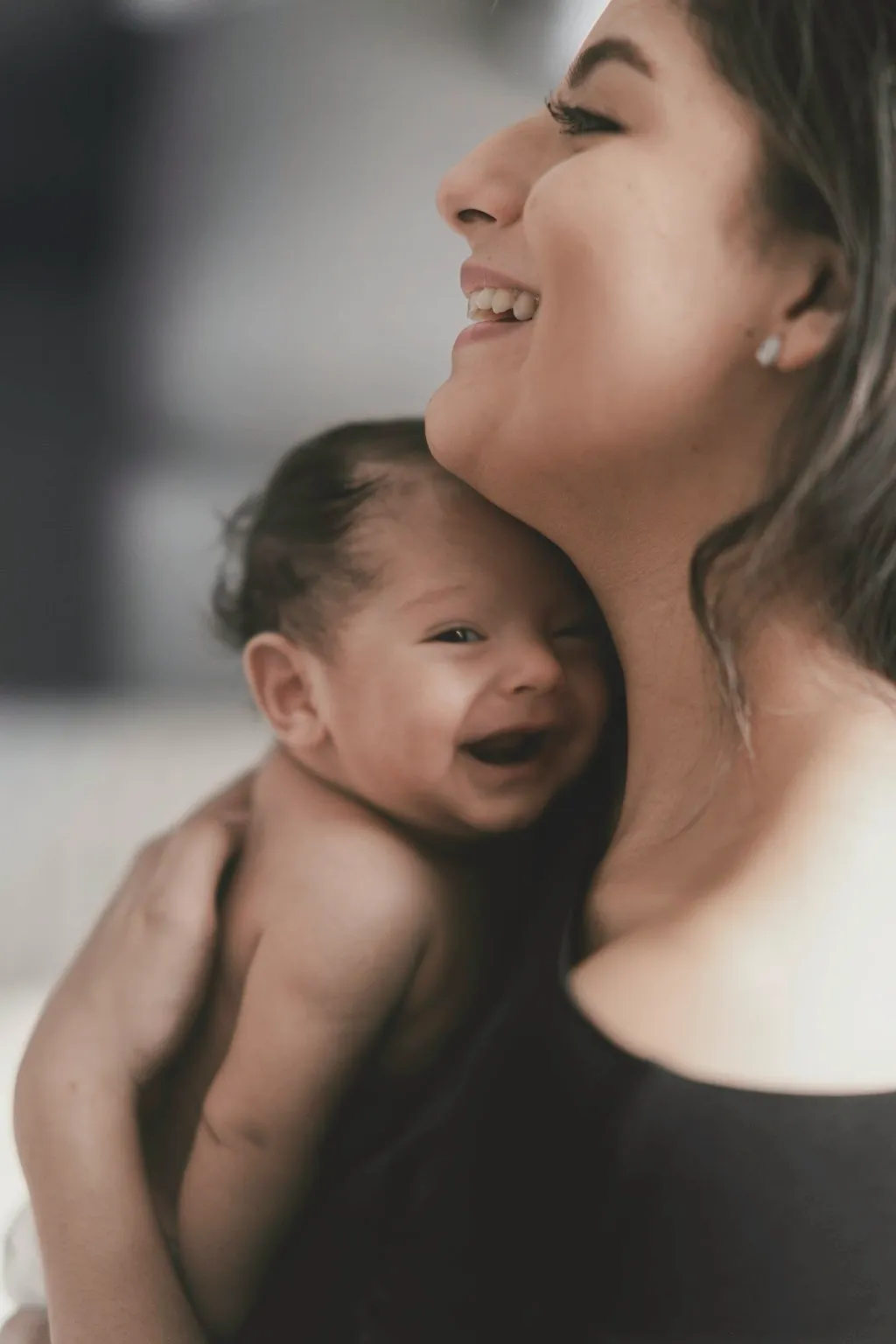 Editorial image of a mother embracing her baby